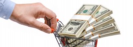 businessman's hand & steel grocery cart full of money stacks - i