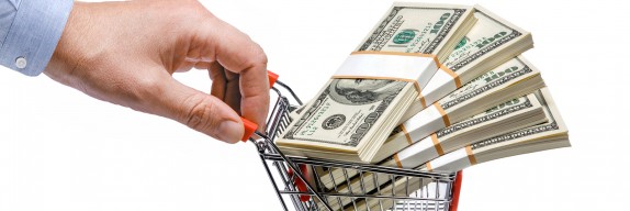 businessman's hand & steel grocery cart full of money stacks - i